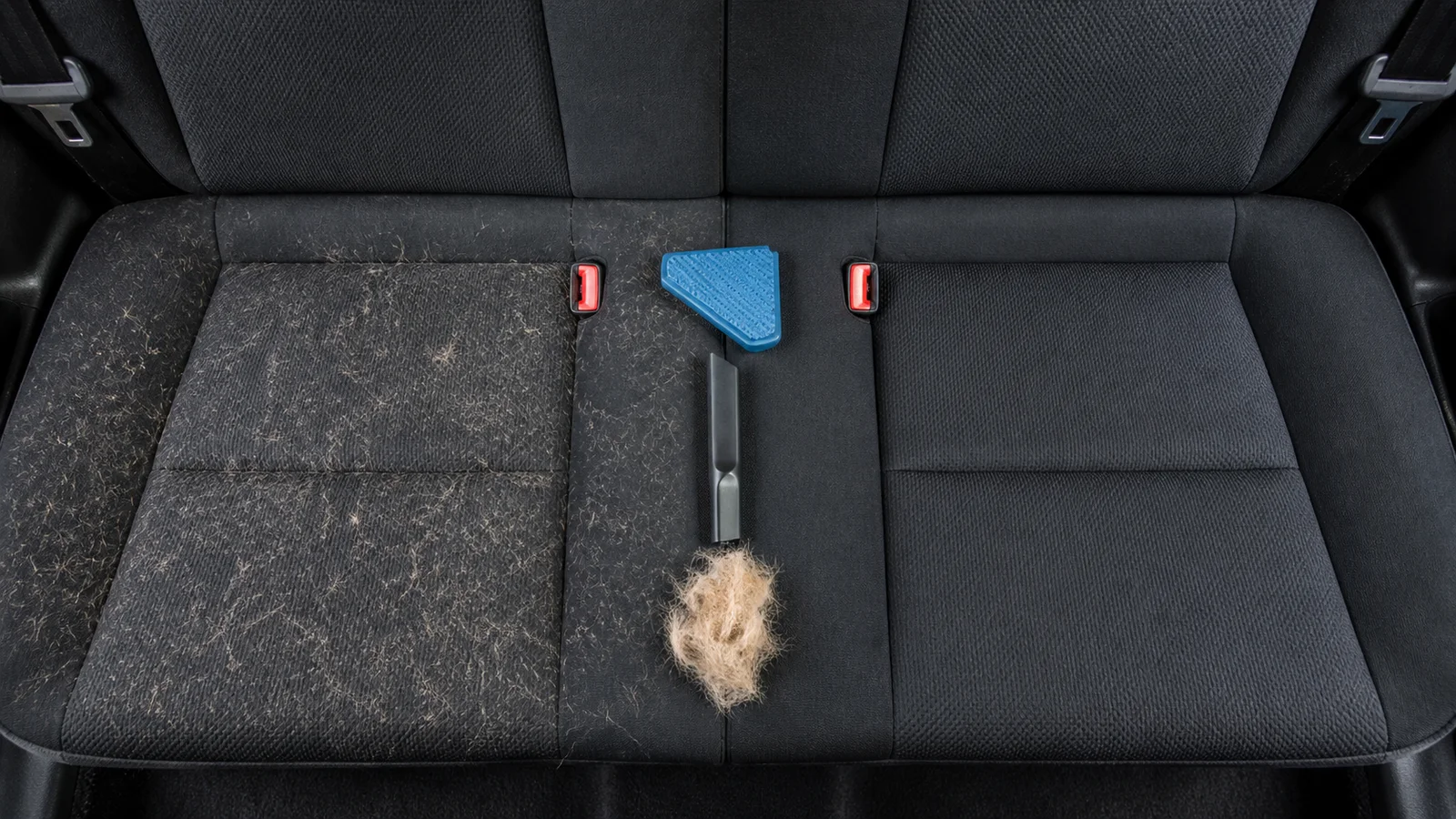 Overhead before-and-after view of pet hair removal from a black cloth rear seat